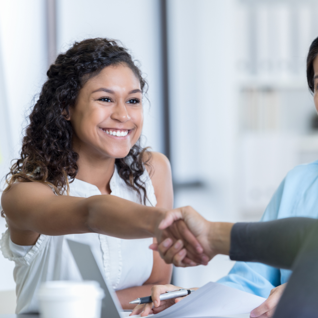 Smiling woman shaking hand